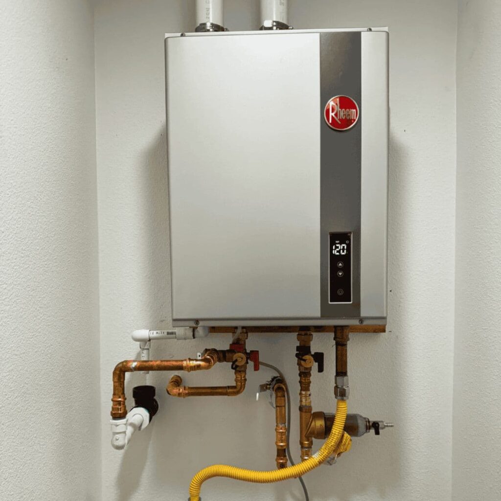 Wall-mounted Rheem tankless water heater with exposed copper piping