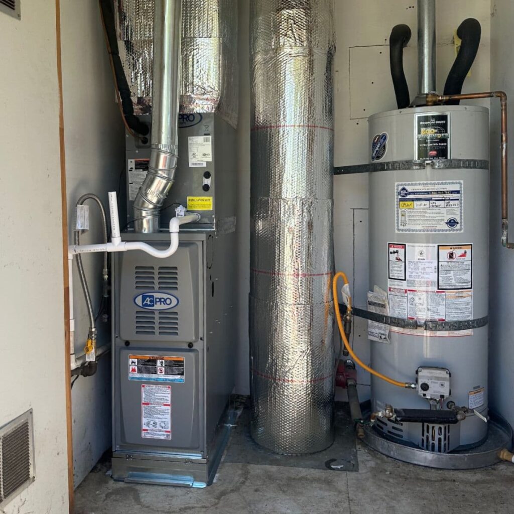 Indoor HVAC furnace and water heater system setup with insulated ductwork and piping