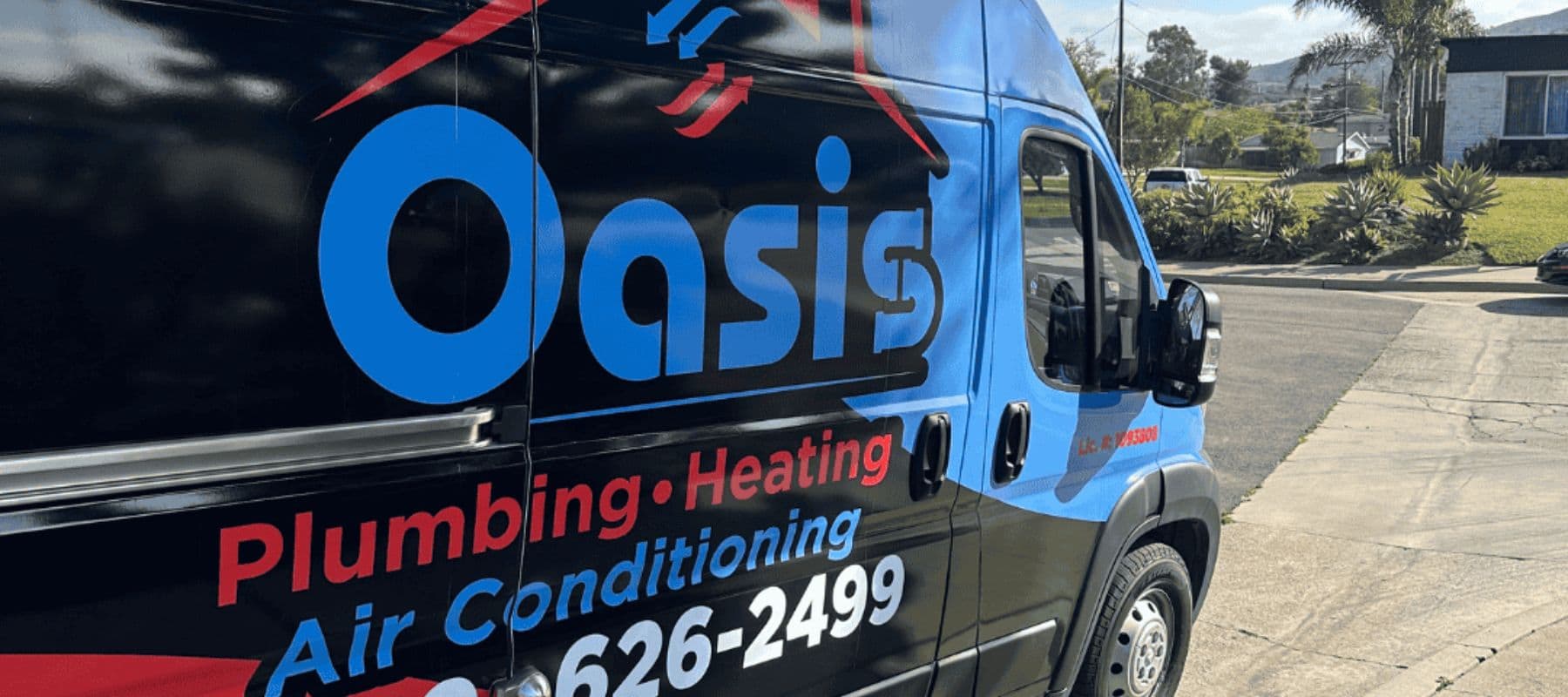 Oasis Plumbing, Heating & Air Conditioning service van parked in a residential neighborhood